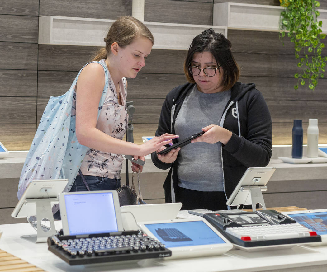 b8ta tester Melissa Avalos, right, helps Jamie Halverson of Iowa City, Iowa, sign up for the ne ...