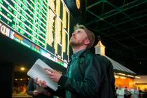 Rufus Peabody, middle, from Boston, waits in line at Westgate Sportsbook as Super Bowl prop bet ...