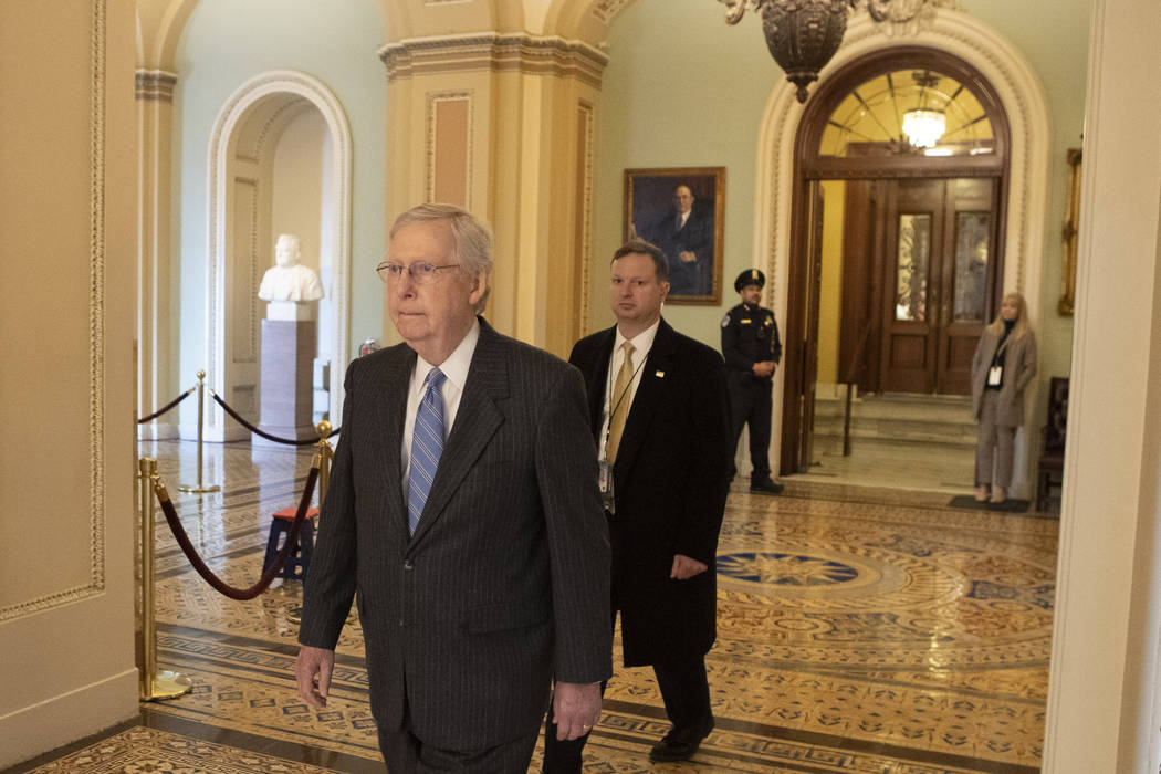Senate Majority Leader Mitch McConnell, R-K.Y., walks to his office past the Senate chamber ent ...