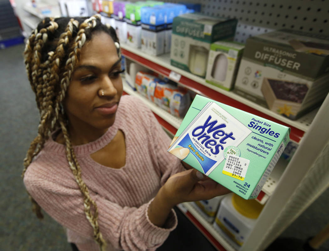 Alice White displays a package of disposal single use wipes at Pucci's Leader Pharmacy in Sacra ...