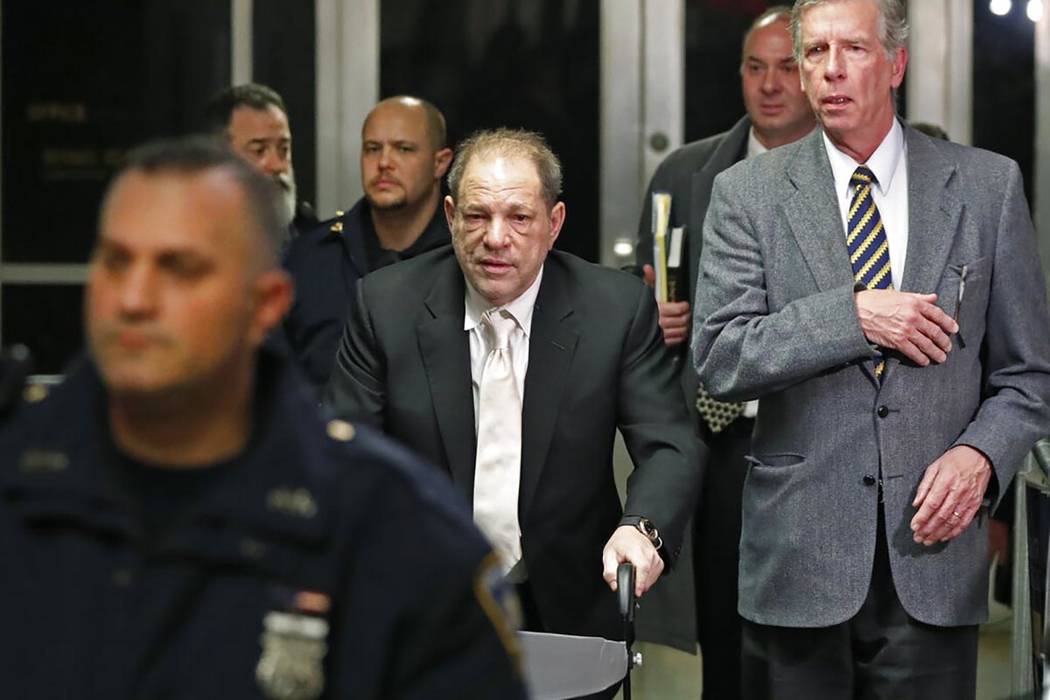 Defendant Harvey Weinstein, center, leaves the courthouse following the second day of his rape ...