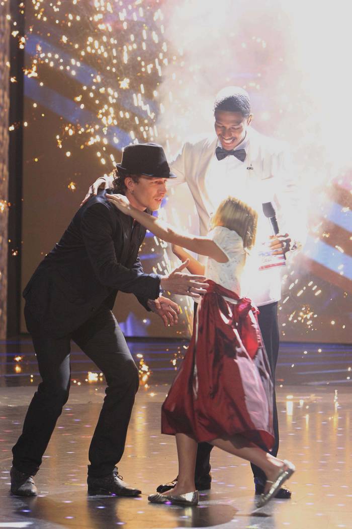 From left, Michael Grimm, Nick Cannon and Jackie Evancho perform in "America's Got Talent." (Tr ...