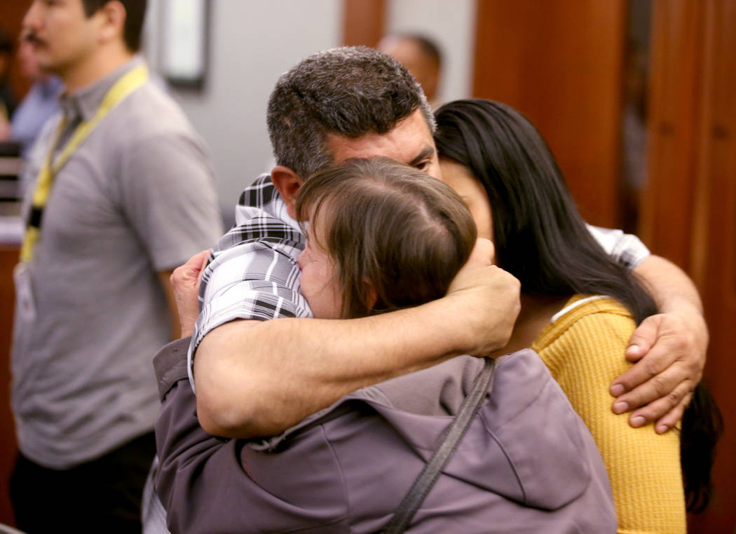 Alice Garcia, sister of Kelly Deanne Kazoon, center, gets a hug from Kazoon's brother-in-law Pa ...