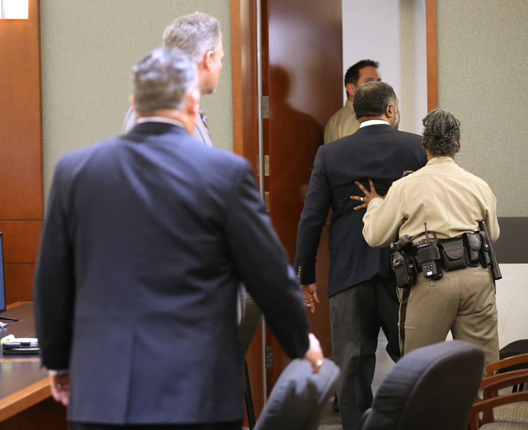 Charles Talley Jr. is pushed out of the courtroom while trying to communicate with members of t ...