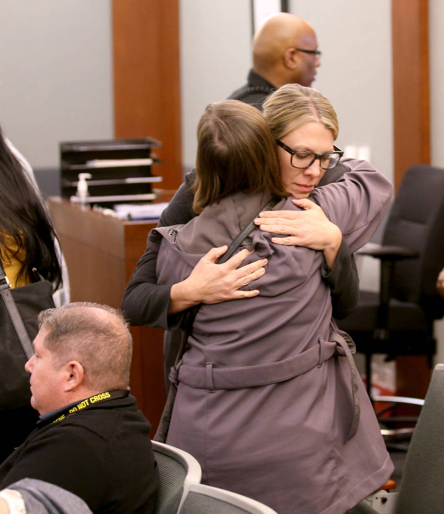 Alice Garcia, back to camera, sister of Kelly Deanne Kazoon, gets a hug from Chief Deputy Distr ...