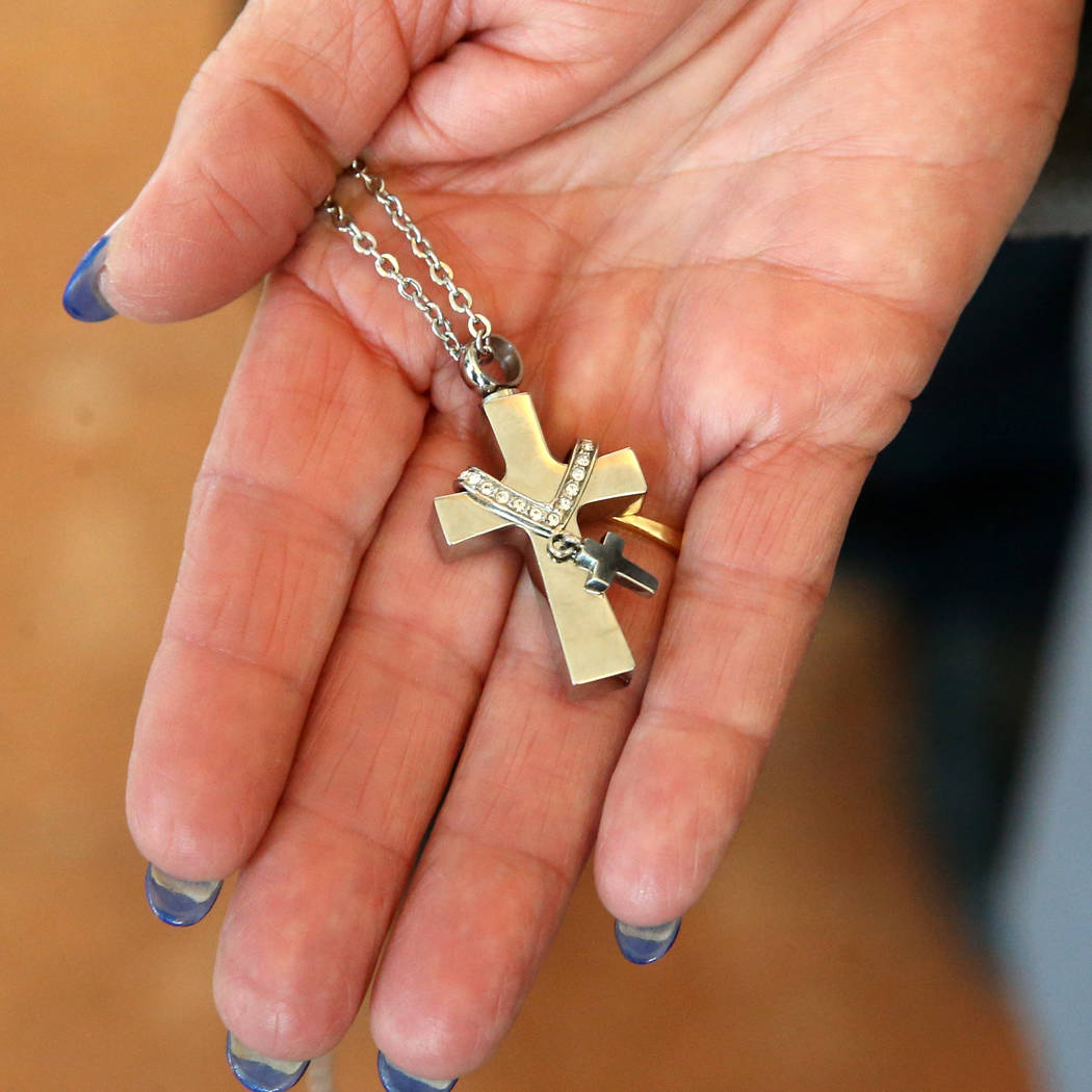 Alice Garcia, sister of Kelly Deanne Kazoon, shows a cross containing her sisters ashes after C ...