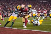 San Francisco 49ers running back Raheem Mostert, center, scores a touchdown next to Green Bay P ...