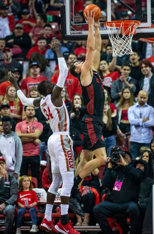 San Diego State Aztecs forward Yanni Wetzell (5, right) dunks the ball over UNLV Rebels forwar ...