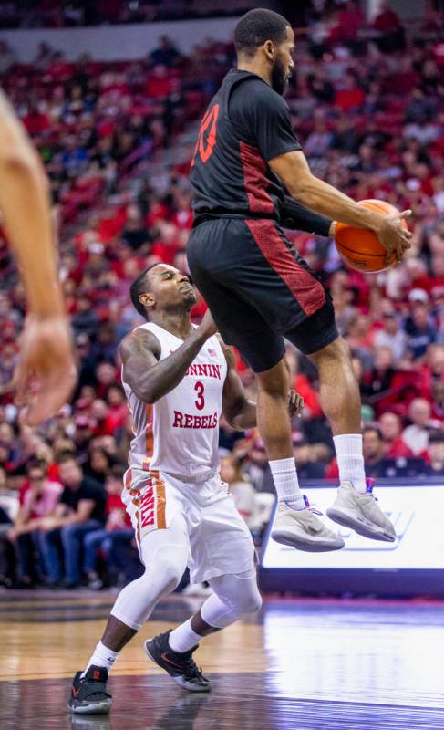 UNLV Rebels guard Amauri Hardy (3, left) loses a rebound to San Diego State Aztecs guard Jordan ...