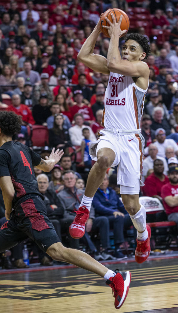 UNLV Rebels guard Marvin Coleman (31, right) looks to the basket on a drive over San Diego Stat ...
