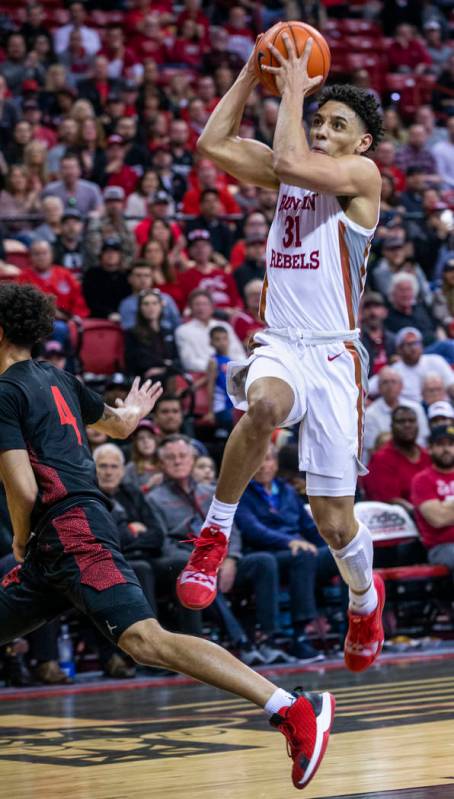 UNLV Rebels guard Marvin Coleman (31, right) looks to the basket on a drive over San Diego Stat ...