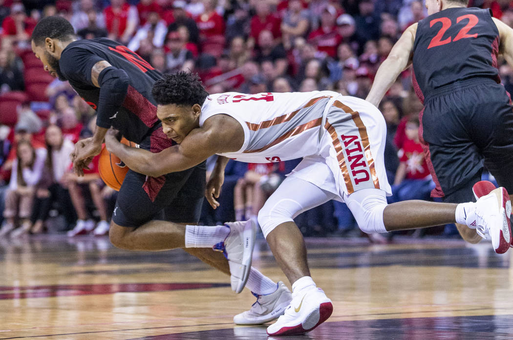 UNLV Rebels guard Bryce Hamilton (13, center) loses the ball late to San Diego State Aztecs for ...