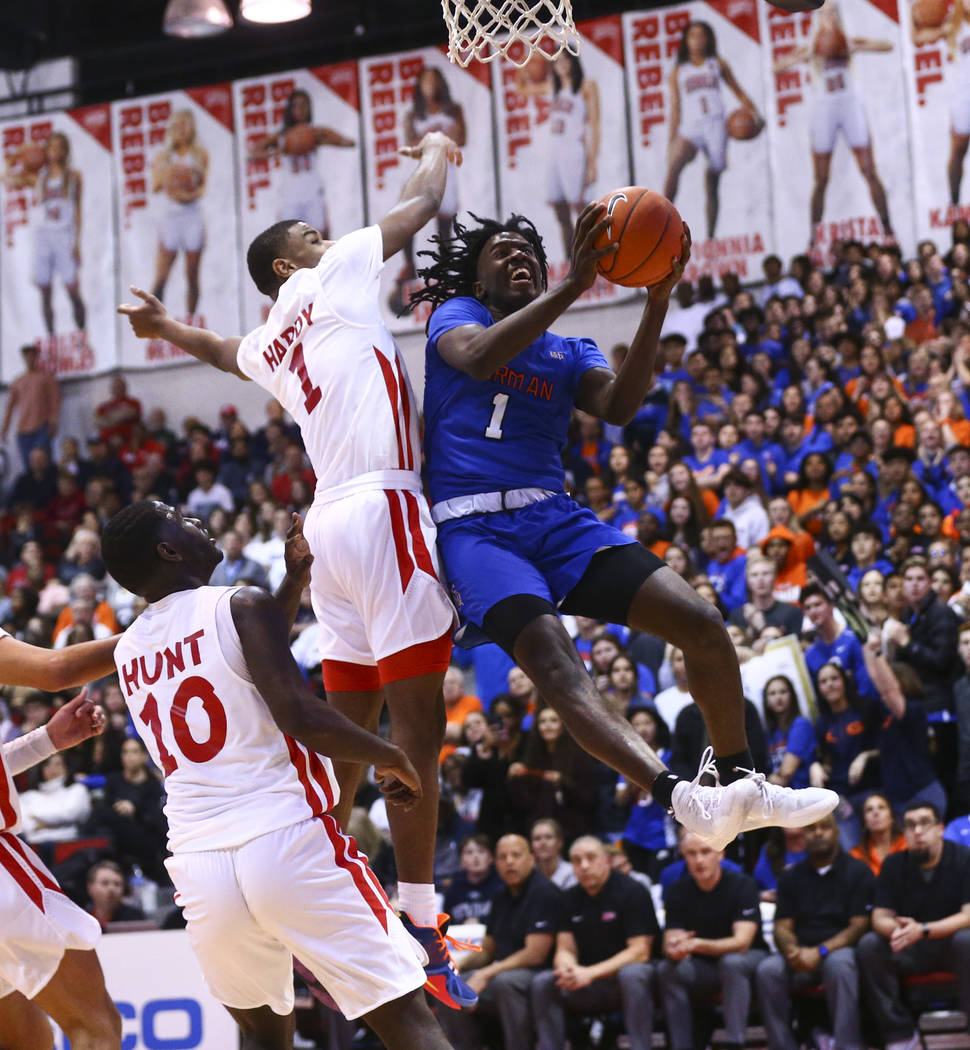 Bishop Gorman's Will McClendon (1) goes to the basket past Coronado's Jaden Hardy (1) during th ...
