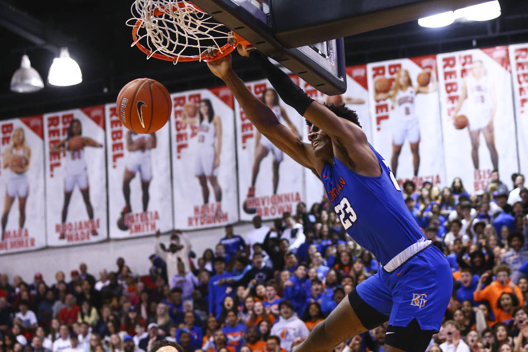 Bishop Gorman's Mwani Wilkinson (23) dunks off an alley-oop during the second half of a basketb ...