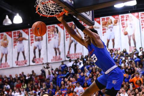 Bishop Gorman's Mwani Wilkinson (23) dunks off an alley-oop during the second half of a basketb ...
