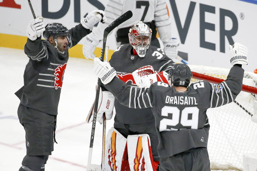 Calgary Flames goalie David Rittich (33) celebrates with Calgary Flames defender Mark Giordano, ...