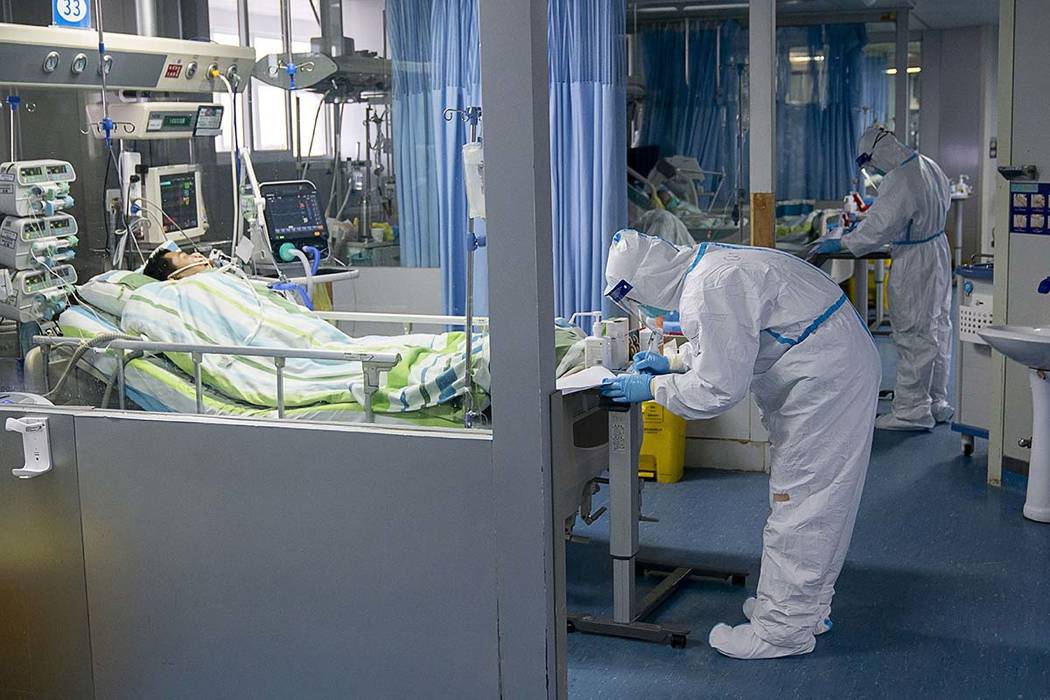 In this Friday, Jan. 24, 2020, photo released by China's Xinhua News Agency, a medical worker a ...