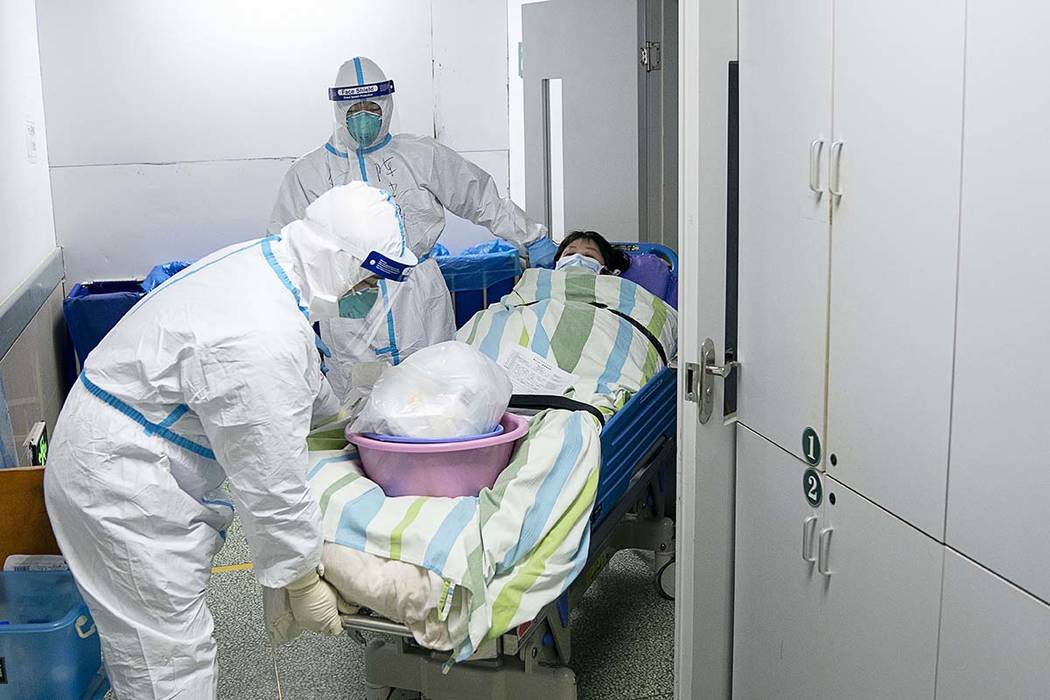 In this Friday, Jan. 24, 2020, photo released by China's Xinhua News Agency, a medical workers ...