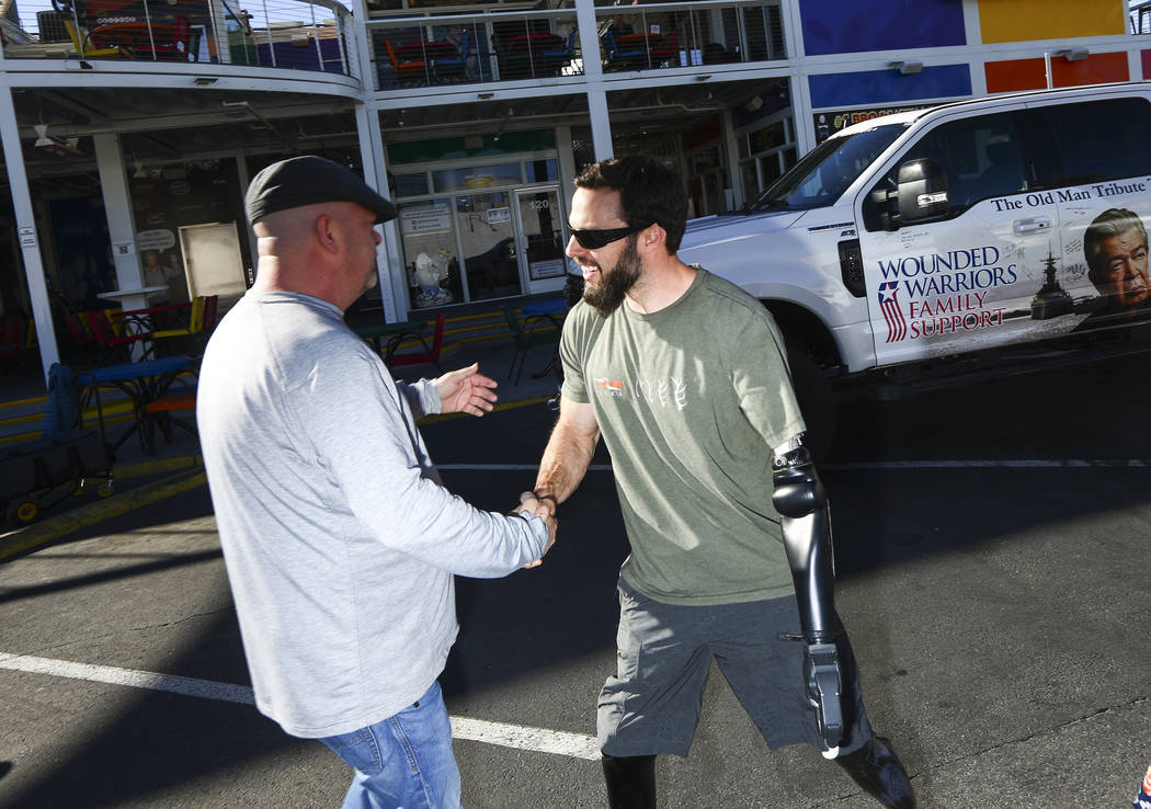 Rick Harrison, left, greets Navy veteran and Purple Heart recipient Andrew Bottrell, who was gi ...