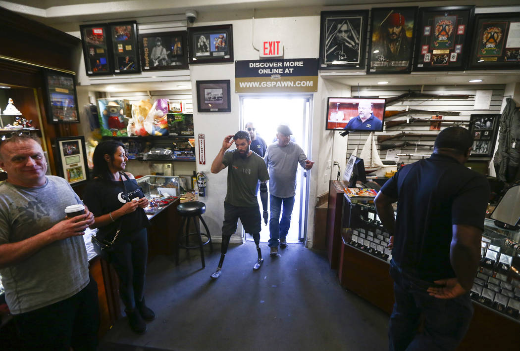 Rick Harrison, right, walks into Gold & Silver Pawn with Navy veteran and Purple Heart reci ...