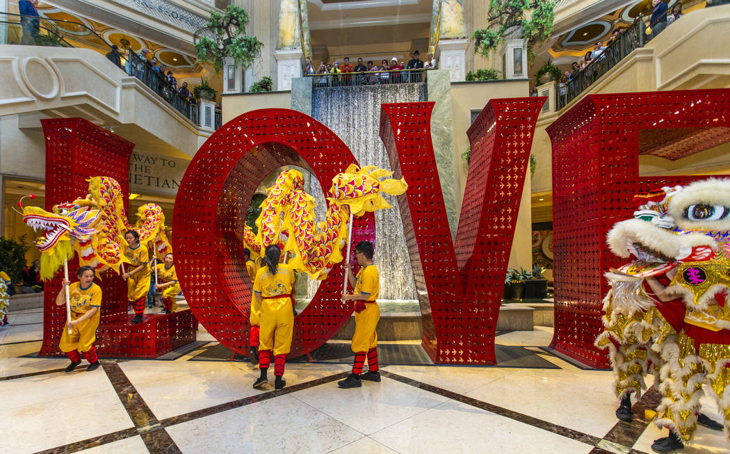 Performers with Yau Kung Moon dance troupe from San Francisco weave within the LOVE sculpture t ...
