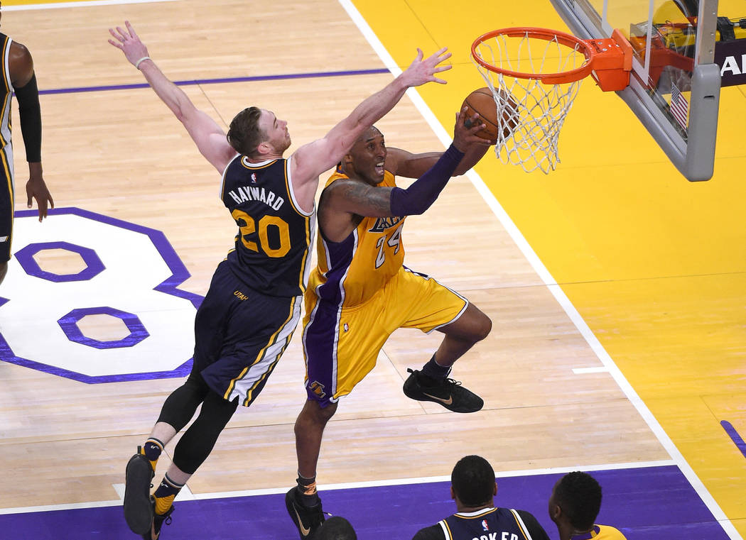 Los Angeles Lakers forward Kobe Bryant, right, shoots as Utah Jazz forward Gordon Hayward defen ...