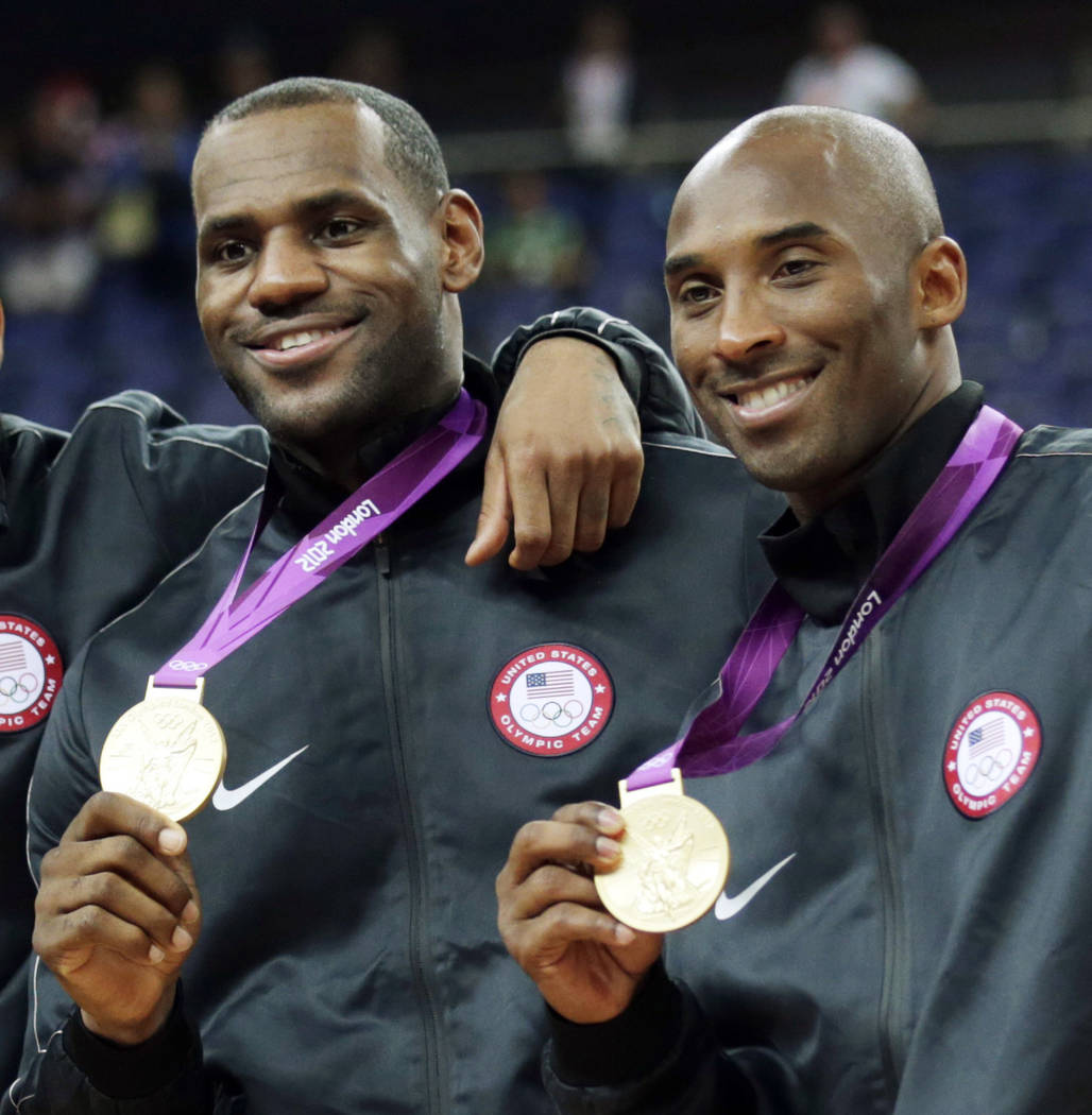 FILE - In this Aug. 12, 2012, file photo, Lebron James, left, and Kobe Bryant pose with their g ...