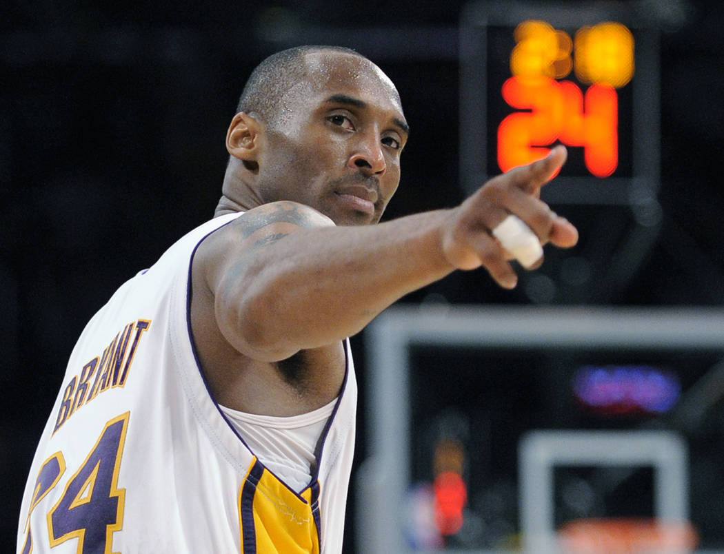 FILE - In this June 7, 2009 file photo Los Angeles Lakers guard Kobe Bryant (24) points to a pl ...
