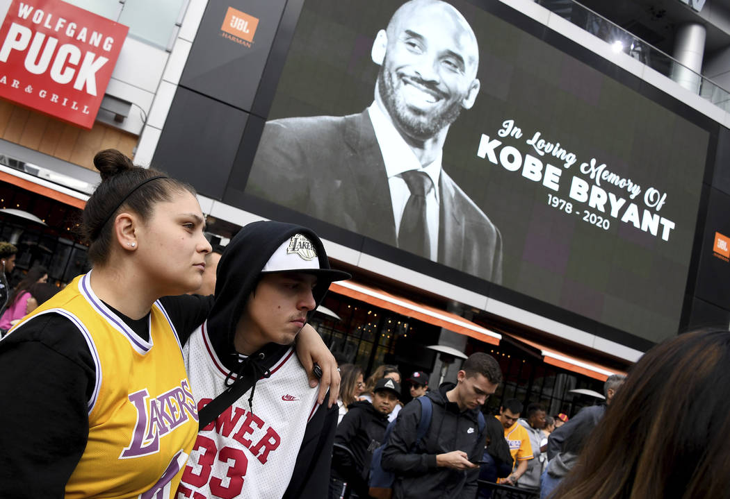 Fans mourn the loss of Kobe Bryant in front of La Live across from Staples Center, home of the ...