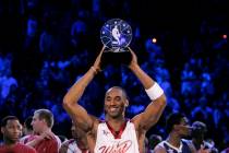 NBA Western Conference player Kobe Bryant holds up the Most Valuable Player trophy after it was ...