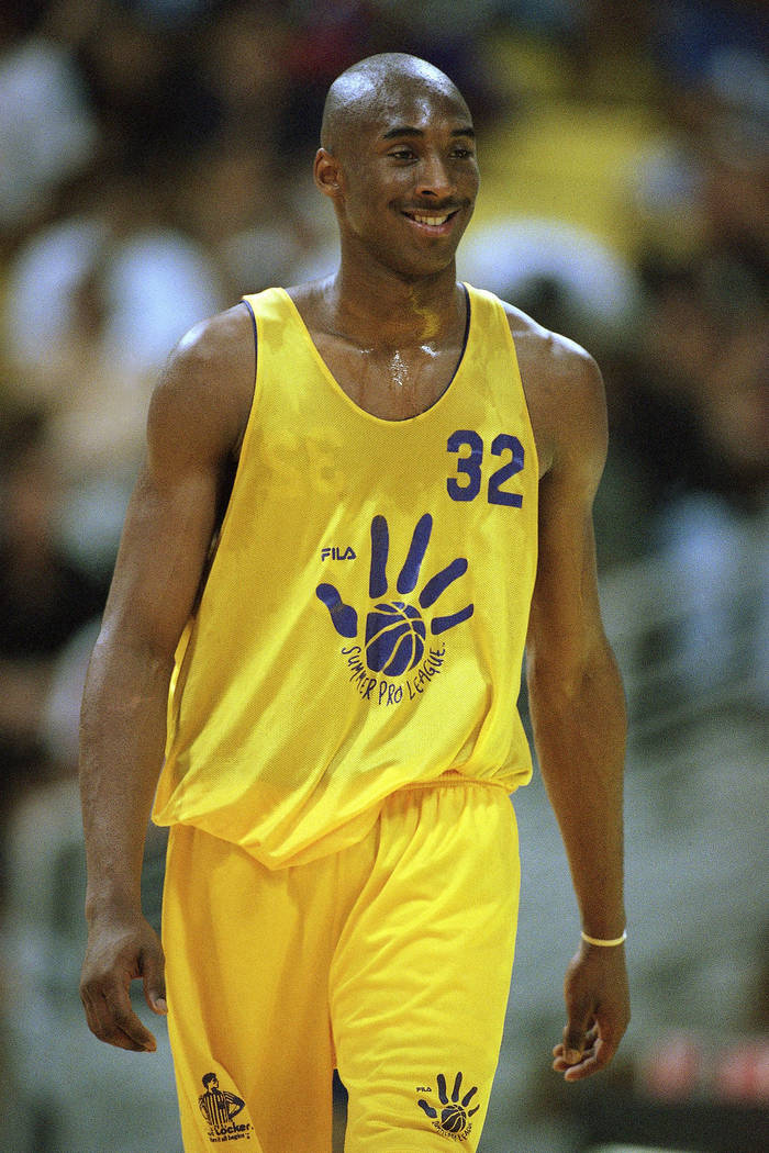 Newly-acquired Los Angeles Laker Kobe Bryant walks downcourt during a summer league game agains ...