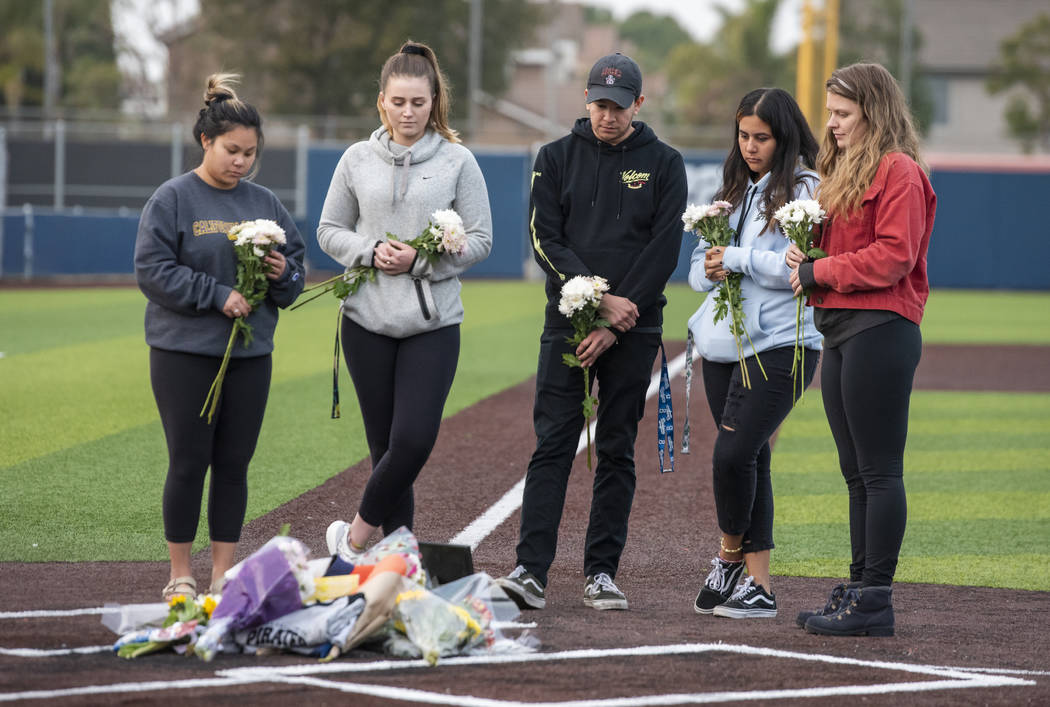 Orange Coast College students and friends of baseball coach John Altobelli lay flowers at home ...