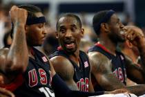 Kobe Bryant, center, and Carmelo Anthony, left, of the USA men's basketball team chat during a ...