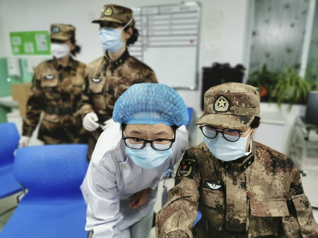 In this Jan. 26, 2020, photo released by Xinhua News Agency, a member of a military medical tea ...