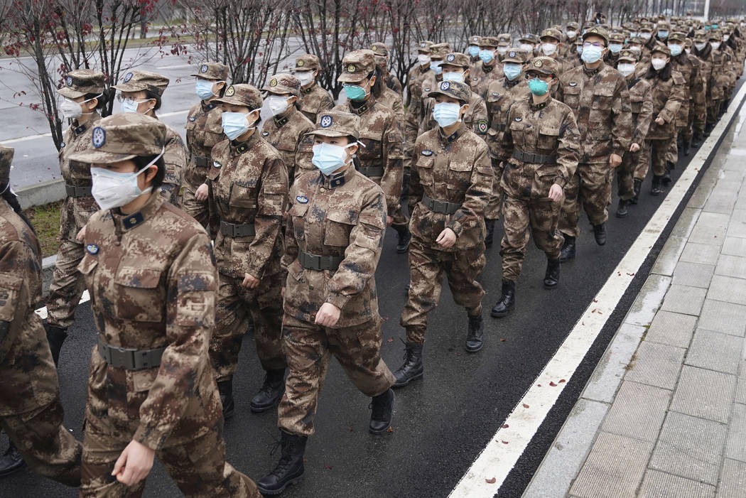 In this Jan. 26, 2020, photo released by Xinhua News Agency, members of a military medical team ...