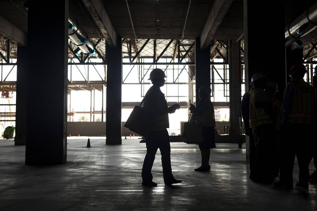 Individuals view the under construction Expo at World Market Center during a tour on Monday, Ja ...