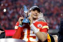 Kansas City Chiefs quarterback Patrick Mahomes holds the Lamar Hunt Trophy as he celebrates win ...