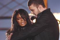 Justin Timberlake reaches across Janet Jackson during their performance just before he pulled o ...