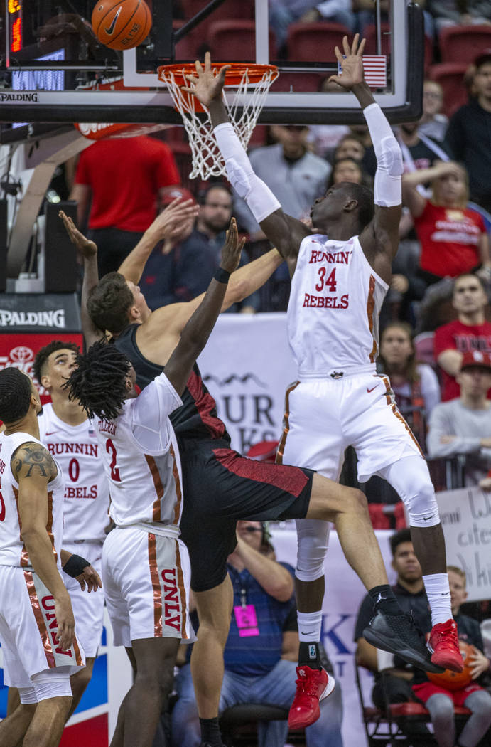 UNLV Rebels forward Cheikh Mbacke Diong (34, right) rejects a shot by San Diego State Aztecs fo ...