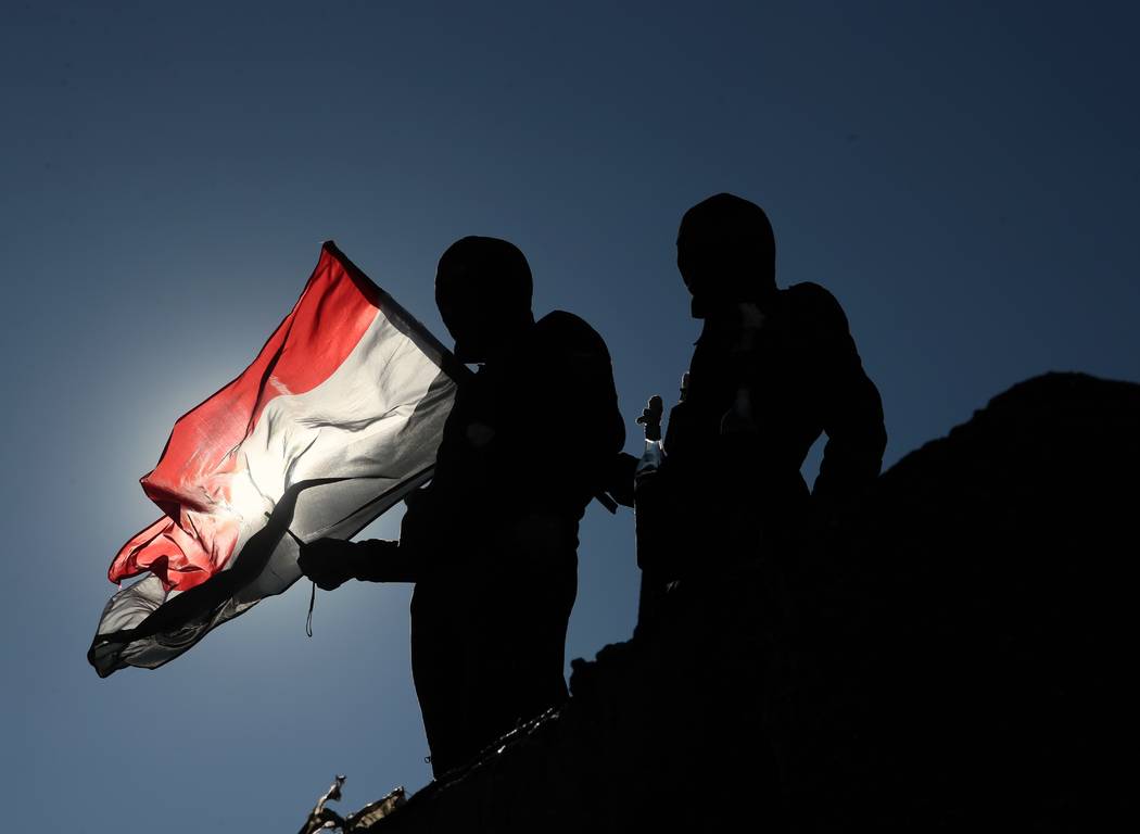 Protesters stage a sit-in on barriers at the Sinak bridge leading to the heavily fortified Gree ...