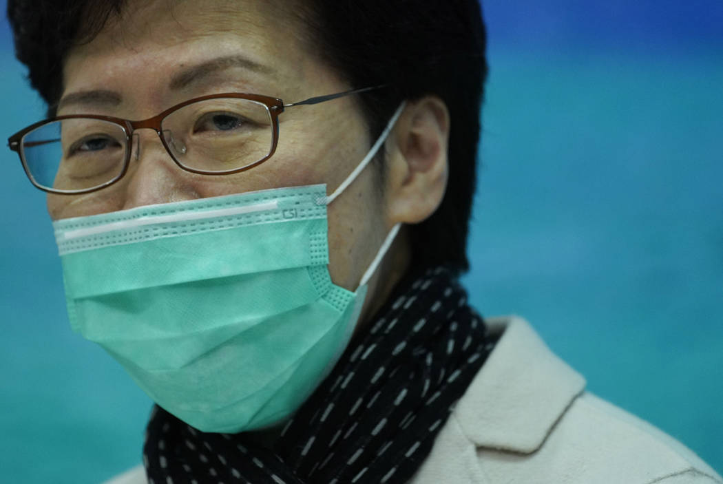 Hong Kong Chief Executive Carrie Lam wears a protective face mask speaks during a press confere ...