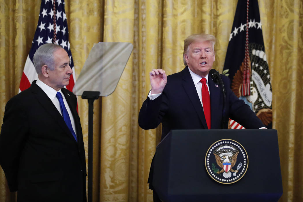 President Donald Trump, joined by Israeli Prime Minister Benjamin Netanyahu, speaks during an e ...