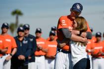 Associate coach Nate Johnson, left, embraces his wife Jonai during a ceremony held for John Alt ...