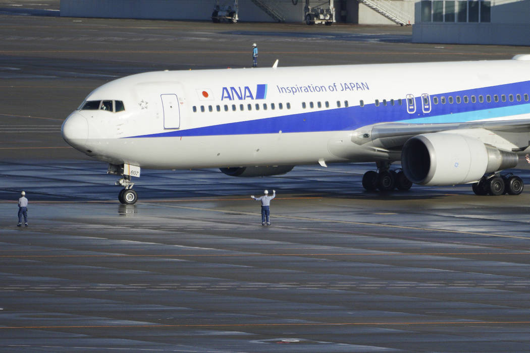 A Japanese chartered plane carrying evacuees from Wuhan, China, landed at Haneda international ...