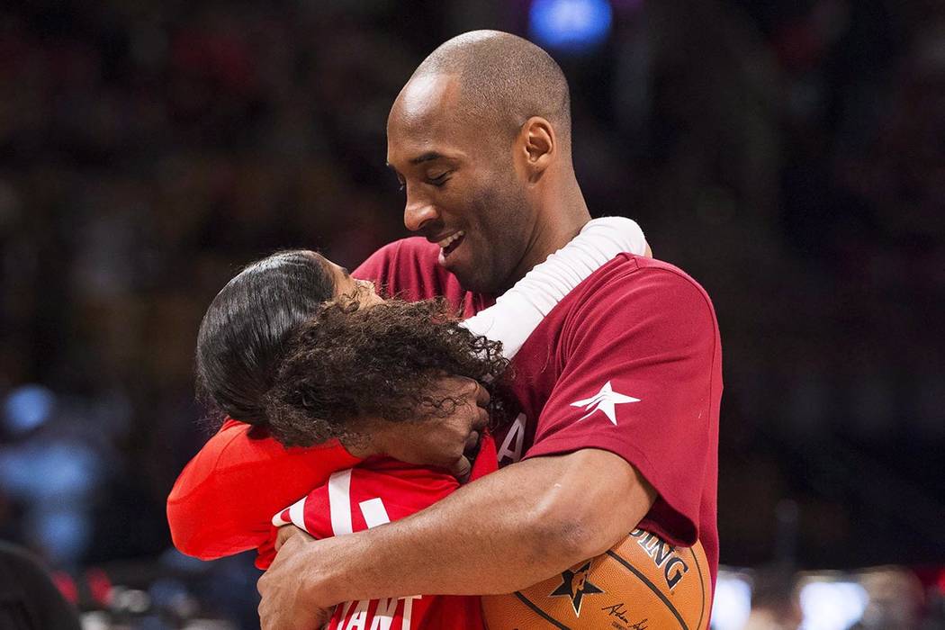 In a Feb. 14, 2016, file photo, Los Angeles Lakers Kobe Bryant (24) hugs his daughter Gianna on ...