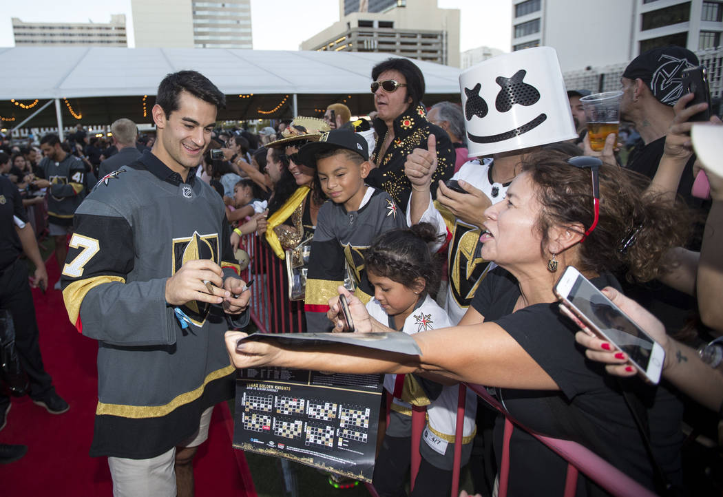 Vegas Golden Knights left wing Max Pacioretty (67), left, signs autographs during a Vegas Golde ...