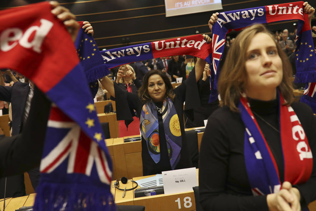 British MEP's hold up scarves during a ceremony prior to the vote on the UK's withdrawal from t ...
