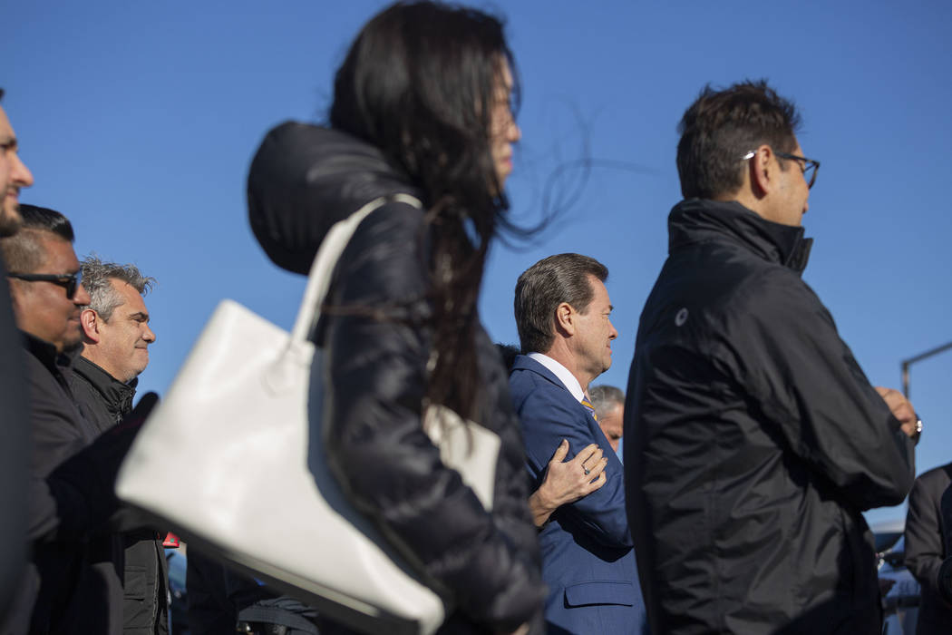 Wind blows as community members listen to speeches during the official opening ceremony for th ...