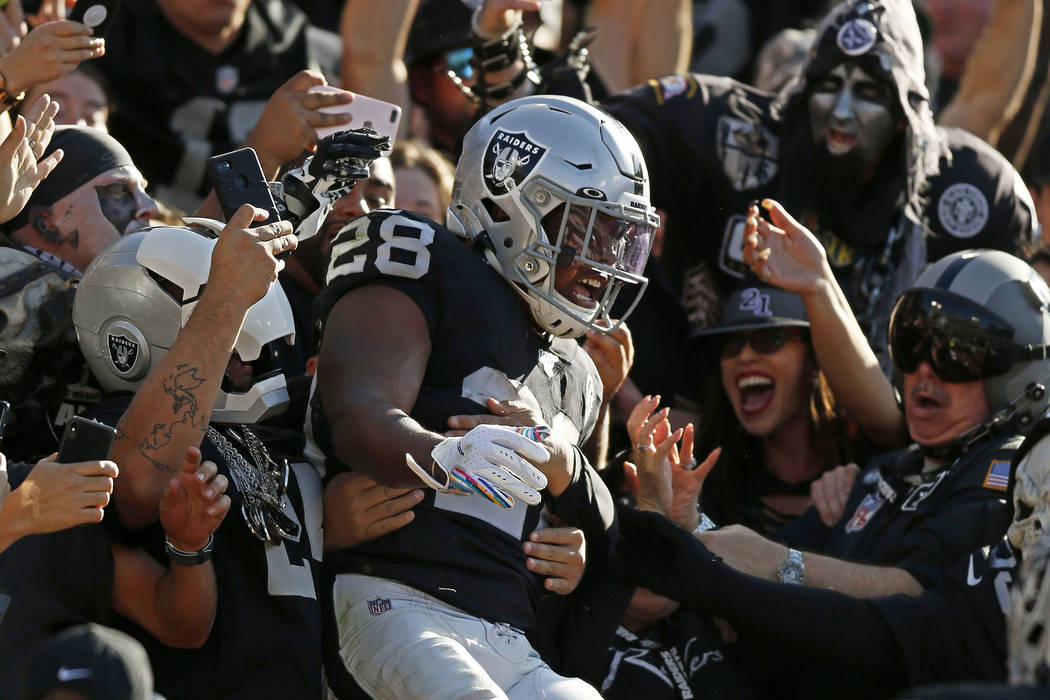 Oakland Raiders running back Josh Jacobs celebrates with fans after scoring against the Detroit ...