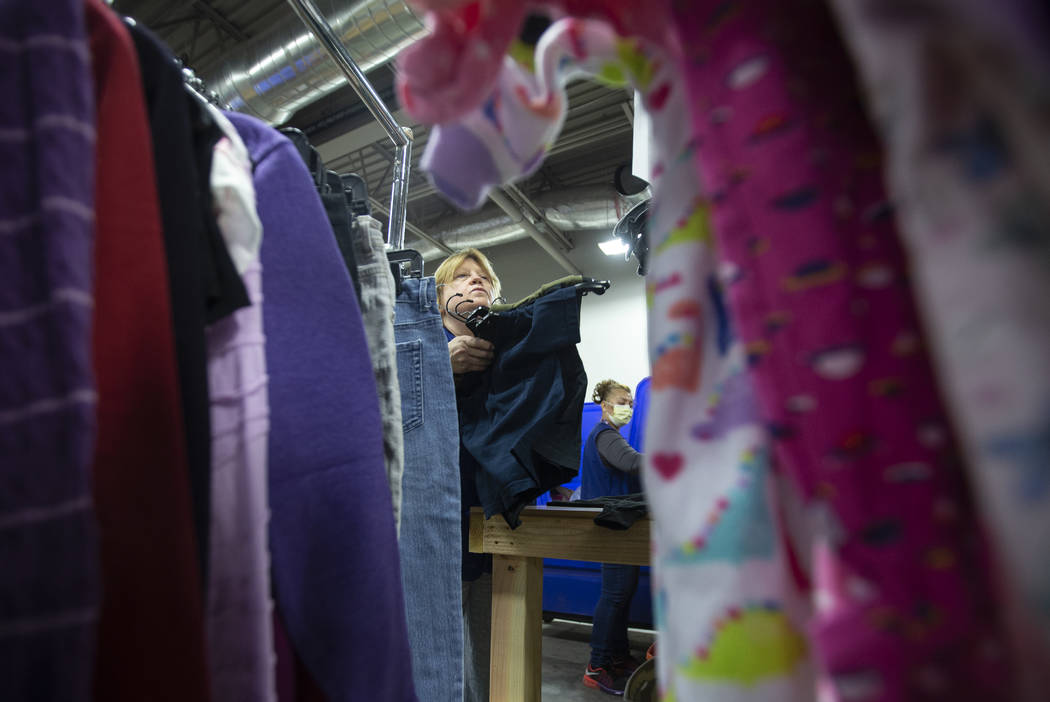 Linda Muth, top/left, sorts through donated clothing at Goodwill of Southern Nevada on Wednesda ...